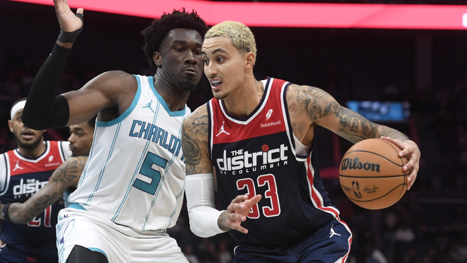 Washington Wizards forward Kyle Kuzma (33) drives past Charlotte Hornets center Mark Williams (5) during the second half at the Spectrum Center.