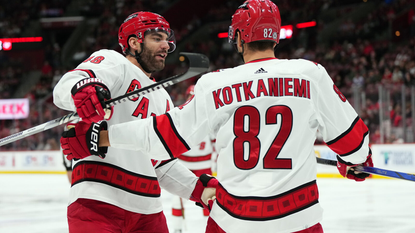 Nov 10, 2023; Sunrise, Florida, USA; Carolina Hurricanes center Jesperi Kotkaniemi (82) celebrates his goal against the Florida Panthers with left wing Jordan Martinook (48) during the first period at Amerant Bank Arena.