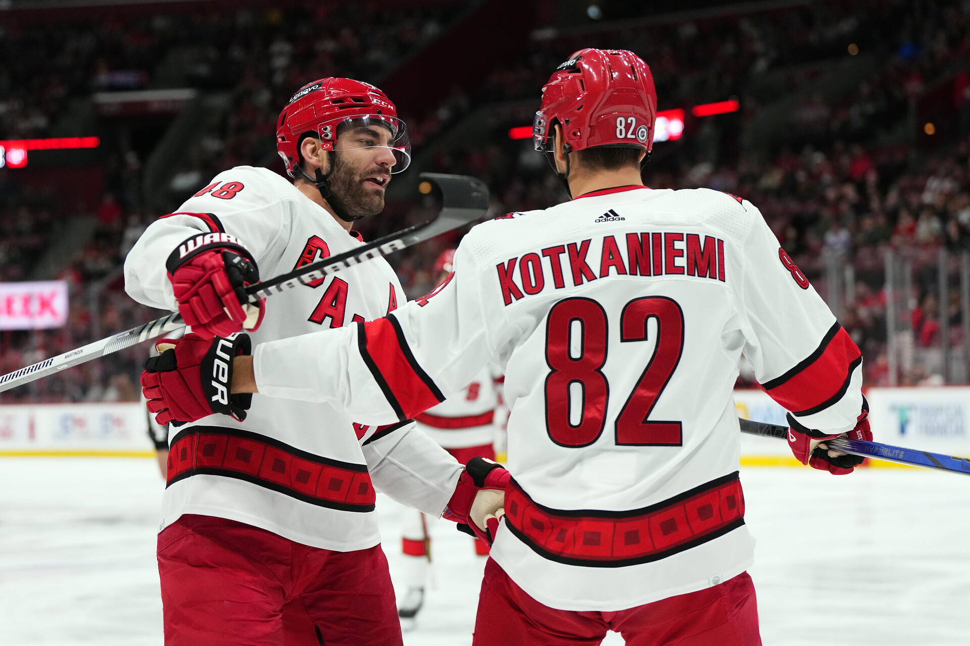 Nov 10, 2023; Sunrise, Florida, USA; Carolina Hurricanes center Jesperi Kotkaniemi (82) celebrates his goal against the Florida Panthers with left wing Jordan Martinook (48) during the first period at Amerant Bank Arena.