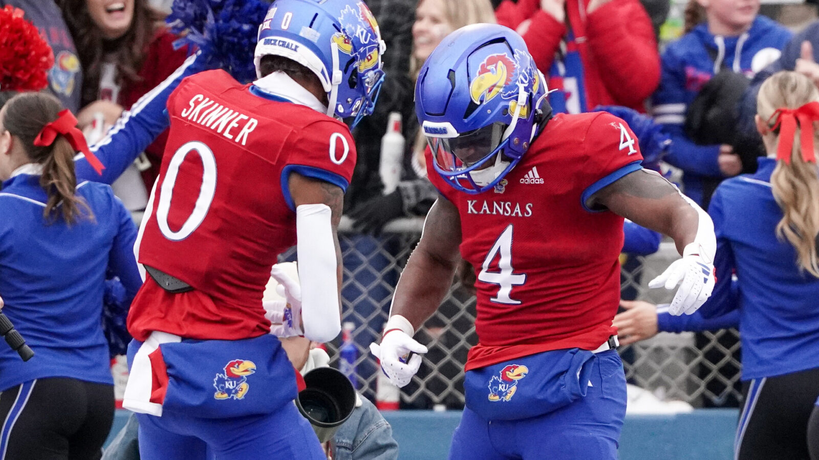 Kansas Jayhawks running back Devin Neal (4) celebrates with wide receiver Quentin Skinner (0) after scoring against the Texas Tech Red Raiders during the second half at David Booth Kansas Memorial Stadium.