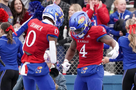 Kansas Jayhawks running back Devin Neal (4) celebrates with wide receiver Quentin Skinner (0) after scoring against the Texas Tech Red Raiders during the second half at David Booth Kansas Memorial Stadium.