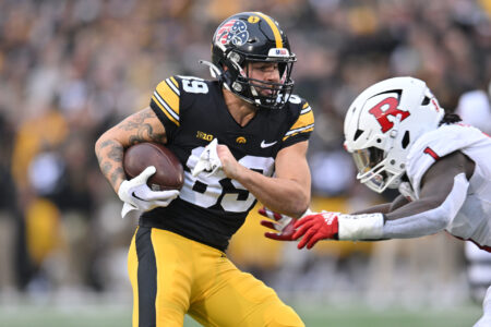 Iowa Hawkeyes wide receiver Nico Ragaini (89) gets yards after catch as Rutgers Scarlet Knights linebacker Mohamed Toure (1) moves in for the tackle during the second quarter at Kinnick Stadium.