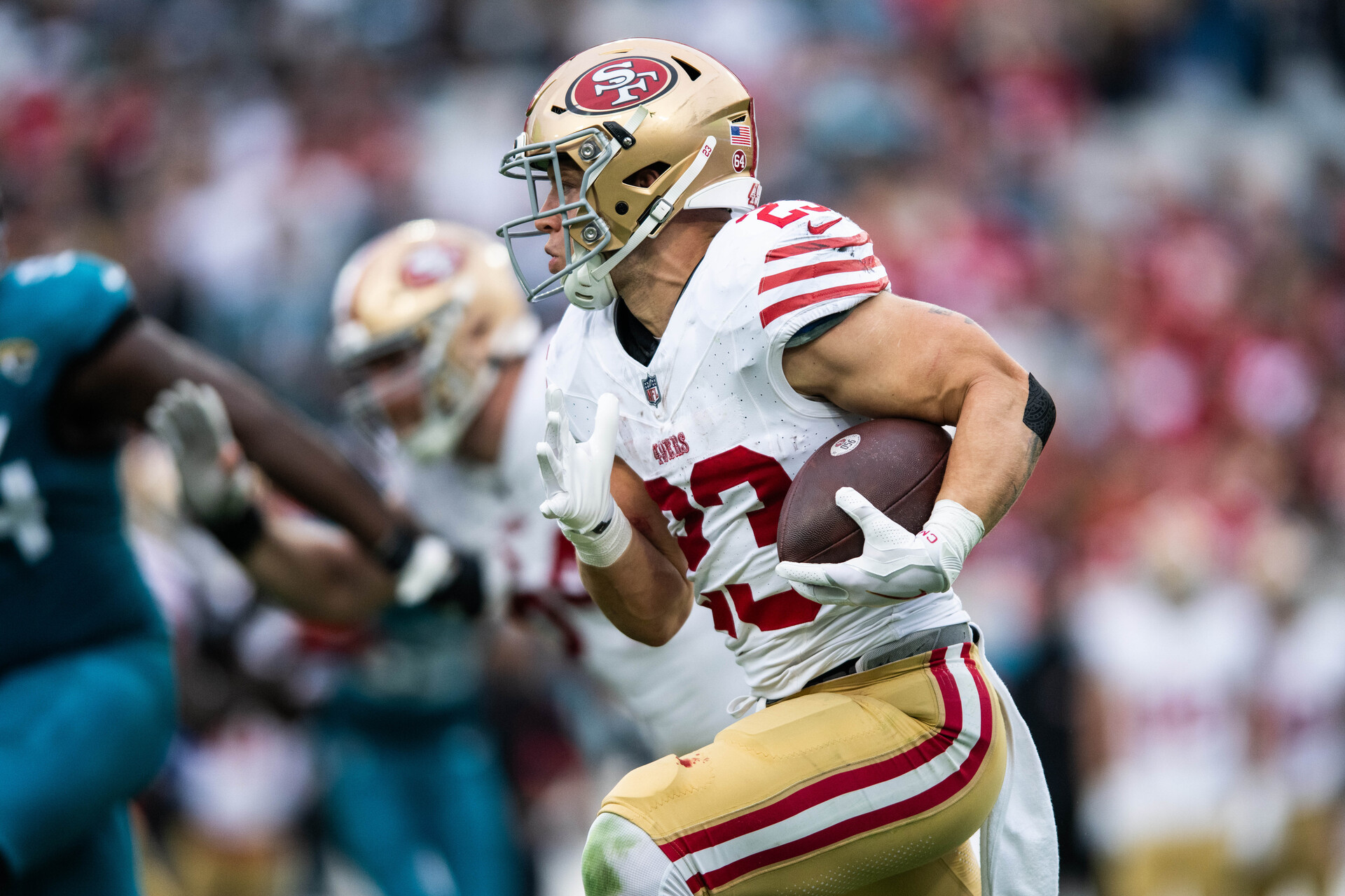 Nov 12, 2023; Jacksonville, Florida, USA; San Fransisco 49ers running back Christian McCaffrey (23) runs with the ball against the Jacksonville Jaguars in the second quarter at EverBank Stadium.