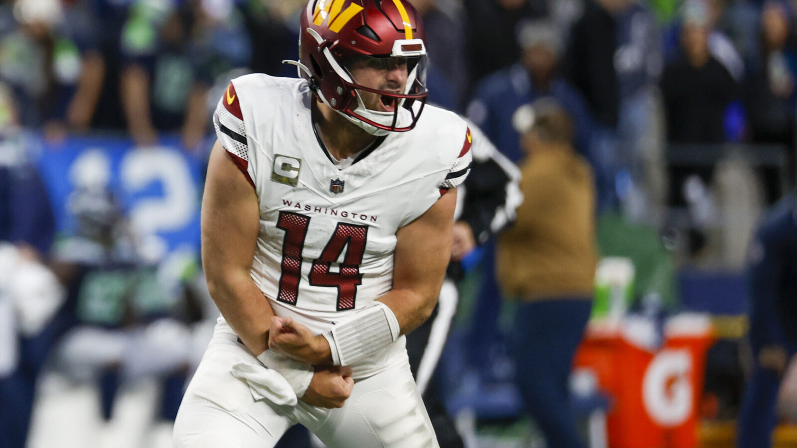 Nov 12, 2023; Seattle, Washington, USA; Washington Commanders quarterback Sam Howell (14) celebrates after throwing a touchdown pass against the Seattle Seahawks during the fourth quarter at Lumen Field.