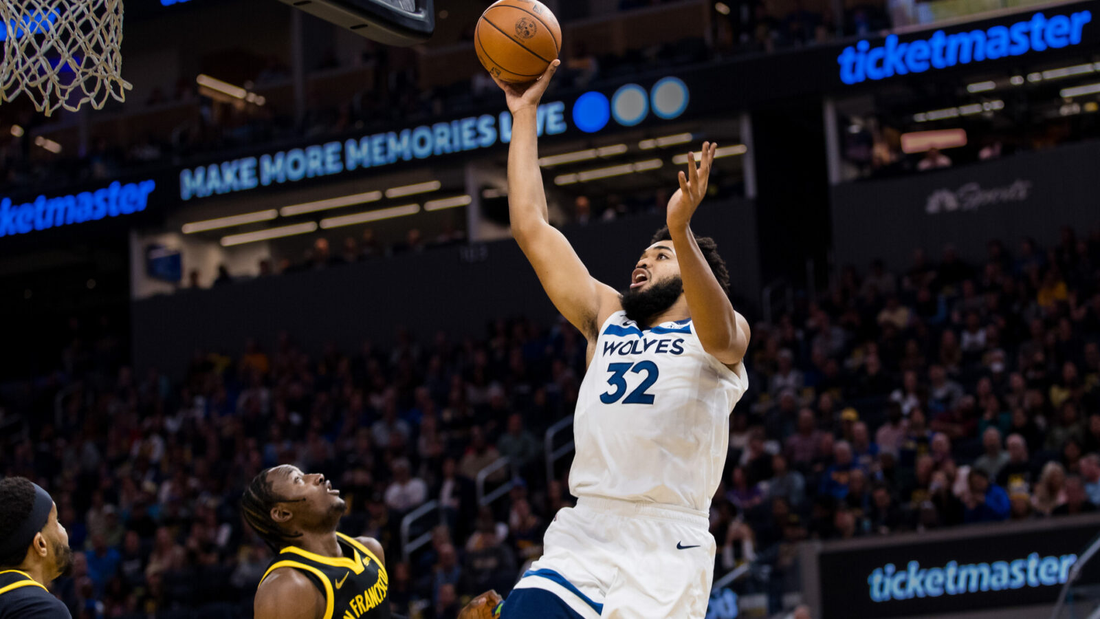 Nov 14, 2023; San Francisco, California, USA; Minnesota Timberwolves forward Karl-Anthony Towns (32) shoots over Golden State Warriors forward Jonathan Kuminga (00) during the first half at Chase Center.