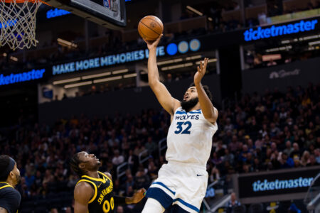 Nov 14, 2023; San Francisco, California, USA; Minnesota Timberwolves forward Karl-Anthony Towns (32) shoots over Golden State Warriors forward Jonathan Kuminga (00) during the first half at Chase Center.