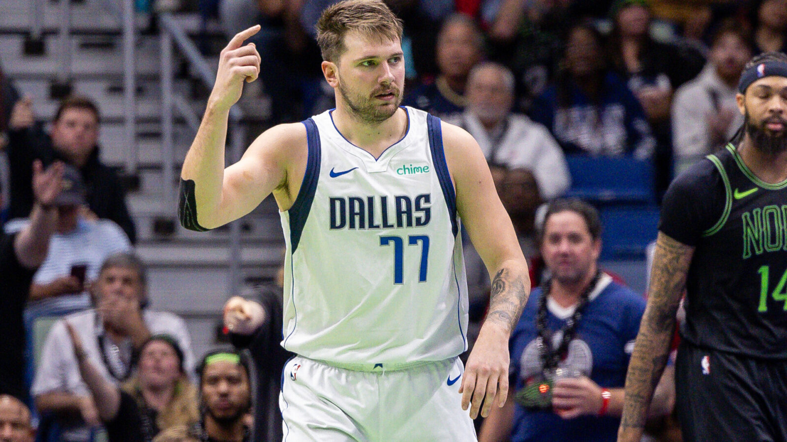 Nov 14, 2023; New Orleans, Louisiana, USA; Dallas Mavericks guard Luka Doncic (77) reacts to a play against New Orleans Pelicans forward Naji Marshall (8) during the second half at the Smoothie King Center.