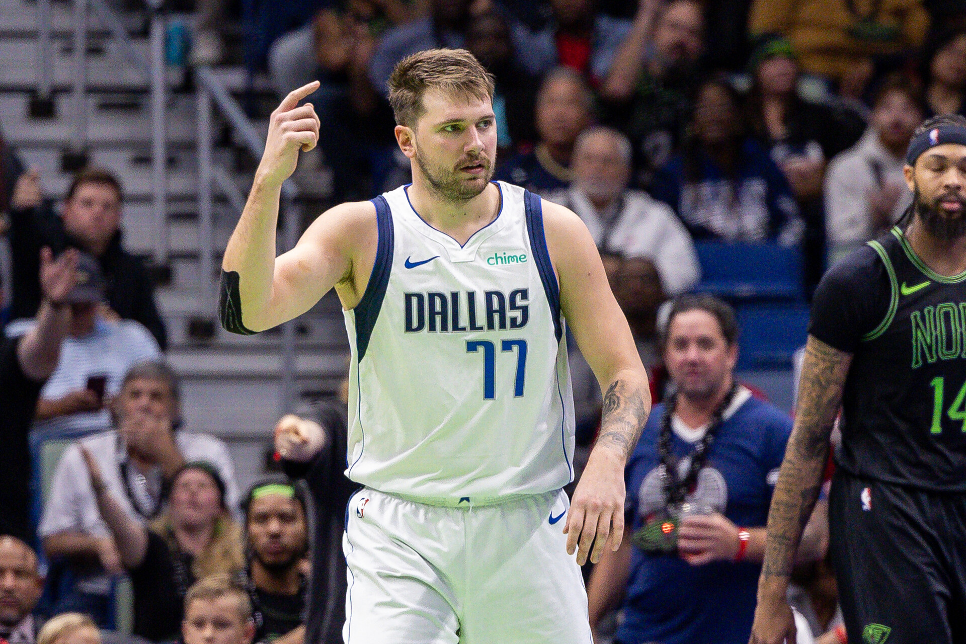 Nov 14, 2023; New Orleans, Louisiana, USA; Dallas Mavericks guard Luka Doncic (77) reacts to a play against New Orleans Pelicans forward Naji Marshall (8) during the second half at the Smoothie King Center.