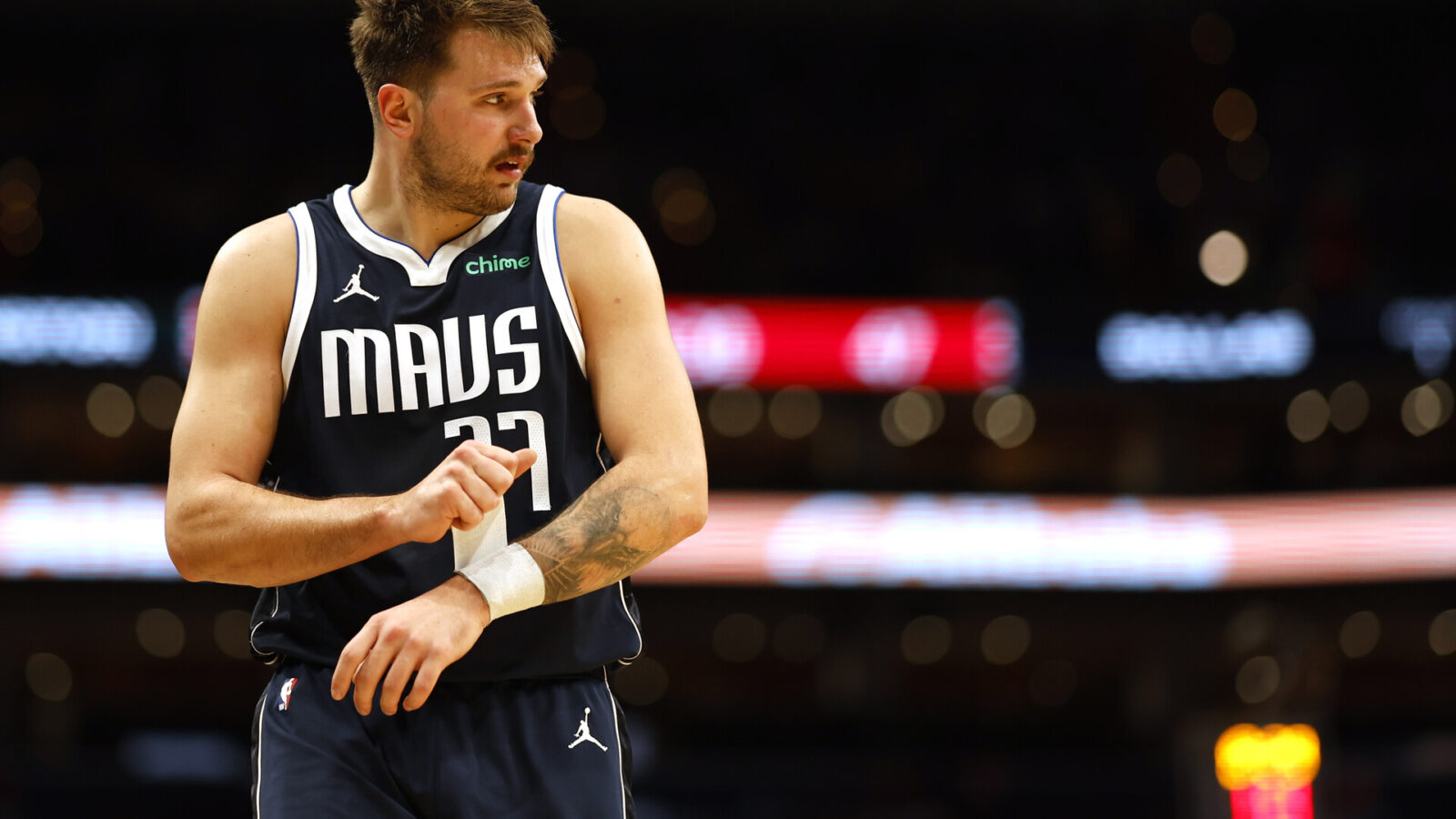 Dallas Mavericks guard Luka Doncic (77) adjusts a wrist wrap against the Washington Wizards in the second quarter at Capital One Arena.