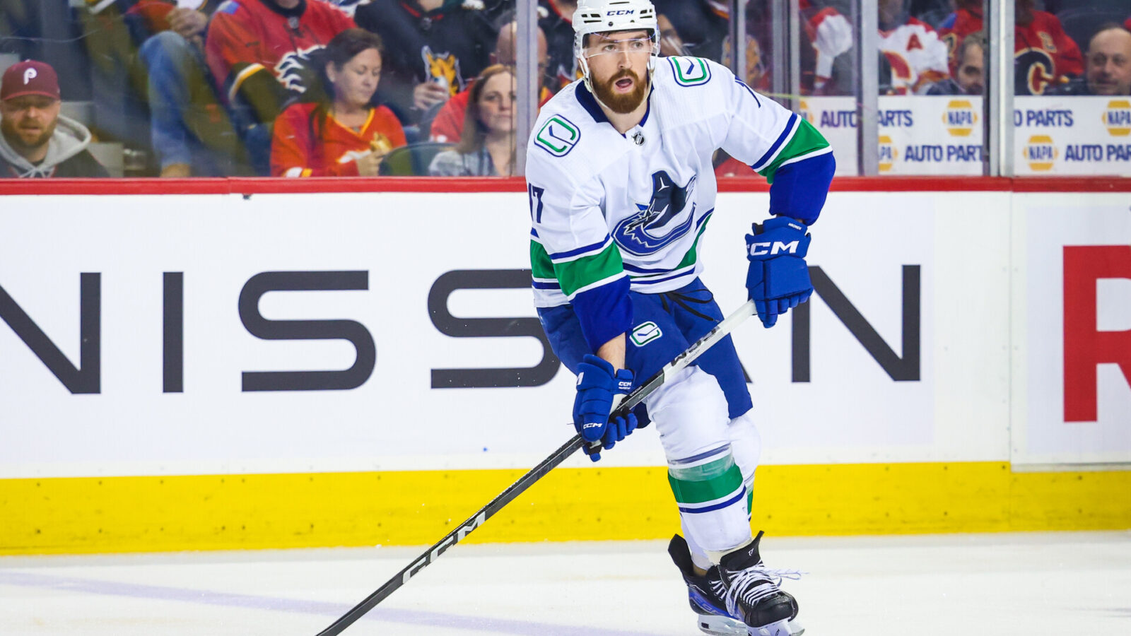 Nov 16, 2023; Calgary, Alberta, CAN; Vancouver Canucks defenseman Filip Hronek (17) controls the puck against the Calgary Flames during the first period at Scotiabank Saddledome
