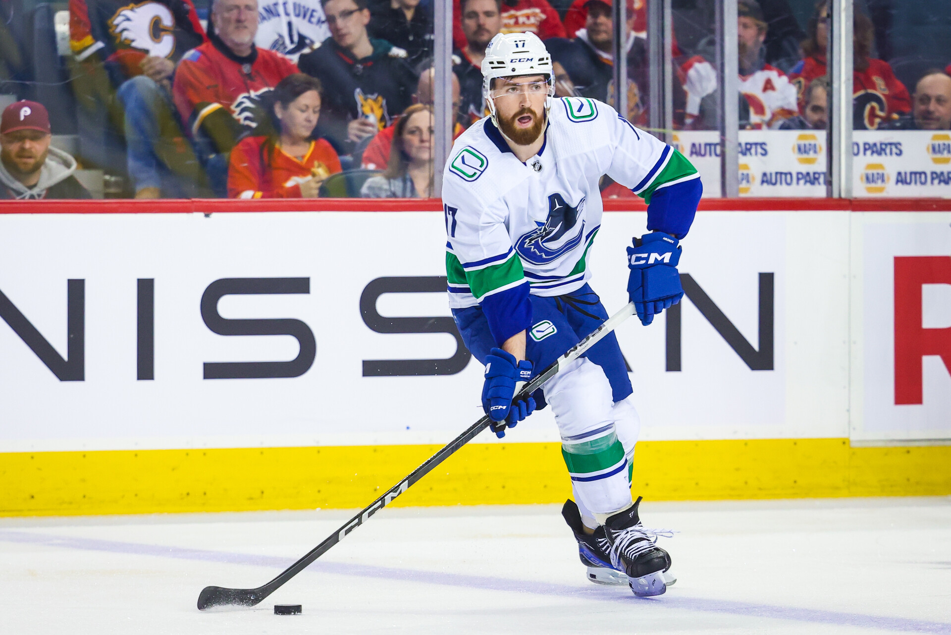 Nov 16, 2023; Calgary, Alberta, CAN; Vancouver Canucks defenseman Filip Hronek (17) controls the puck against the Calgary Flames during the first period at Scotiabank Saddledome