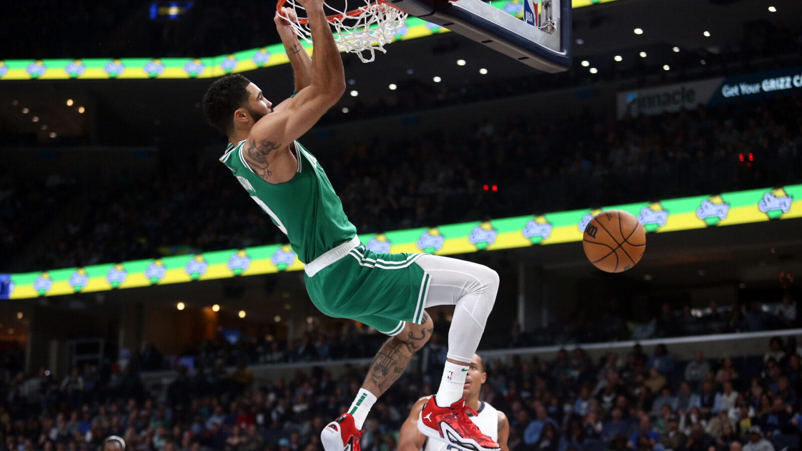 Nov 19, 2023; Memphis, Tennessee, USA; Boston Celtics forward Jayson Tatum (0) dunks during the first half against the Memphis Grizzlies at FedExForum.