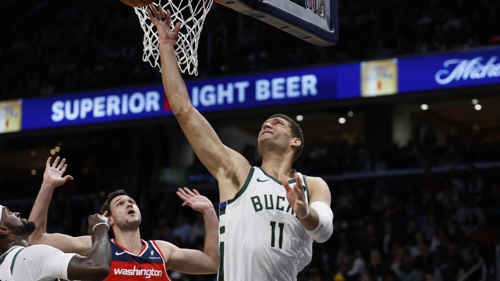 Nov 20, 2023; Washington, District of Columbia, USA; Milwaukee Bucks center Brook Lopez (11) shoots the ball as Washington Wizards forward Danilo Gallinari (88) defends in the fourth quarter at Capital One Arena.
