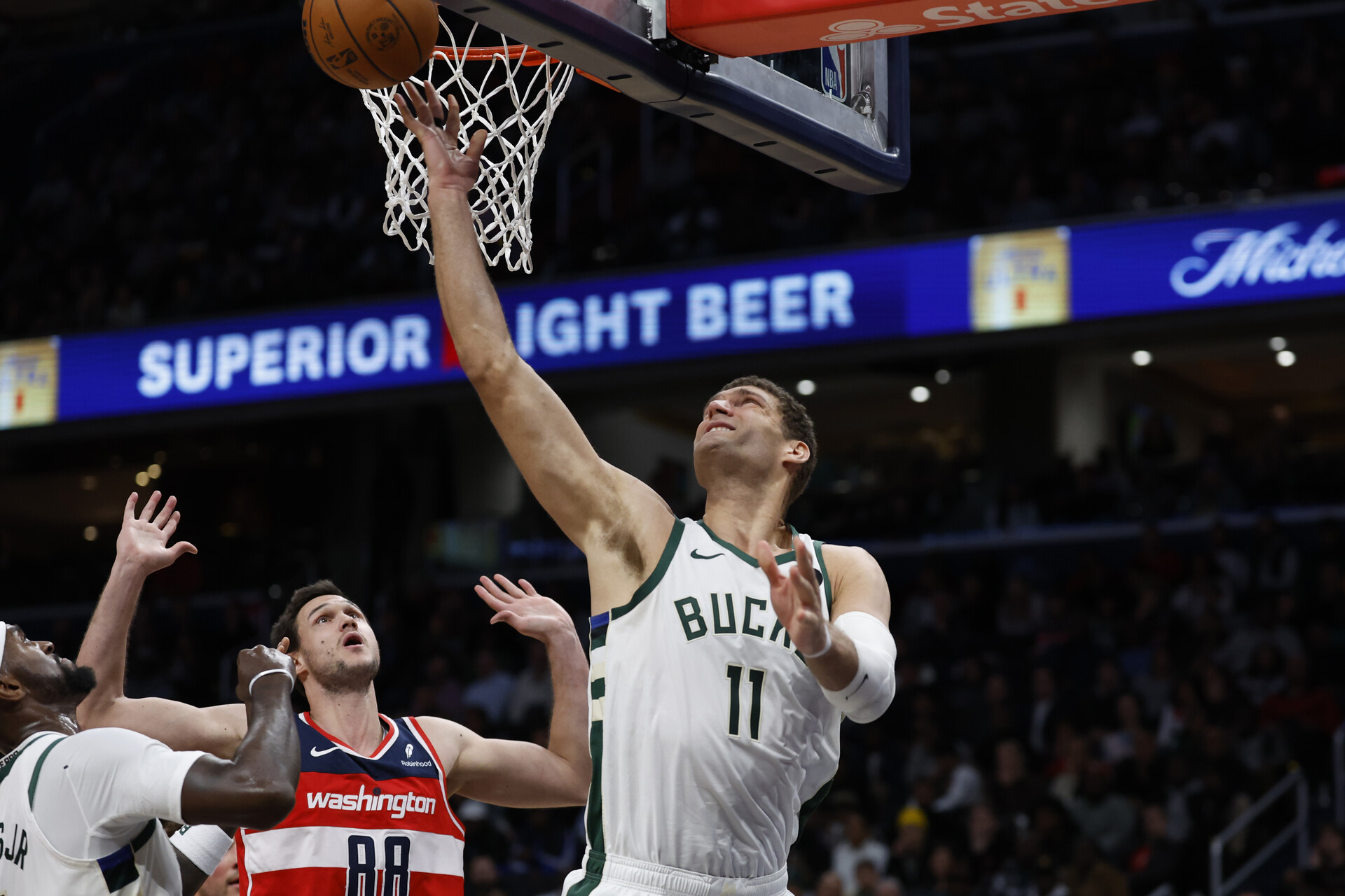 Nov 20, 2023; Washington, District of Columbia, USA; Milwaukee Bucks center Brook Lopez (11) shoots the ball as Washington Wizards forward Danilo Gallinari (88) defends in the fourth quarter at Capital One Arena.