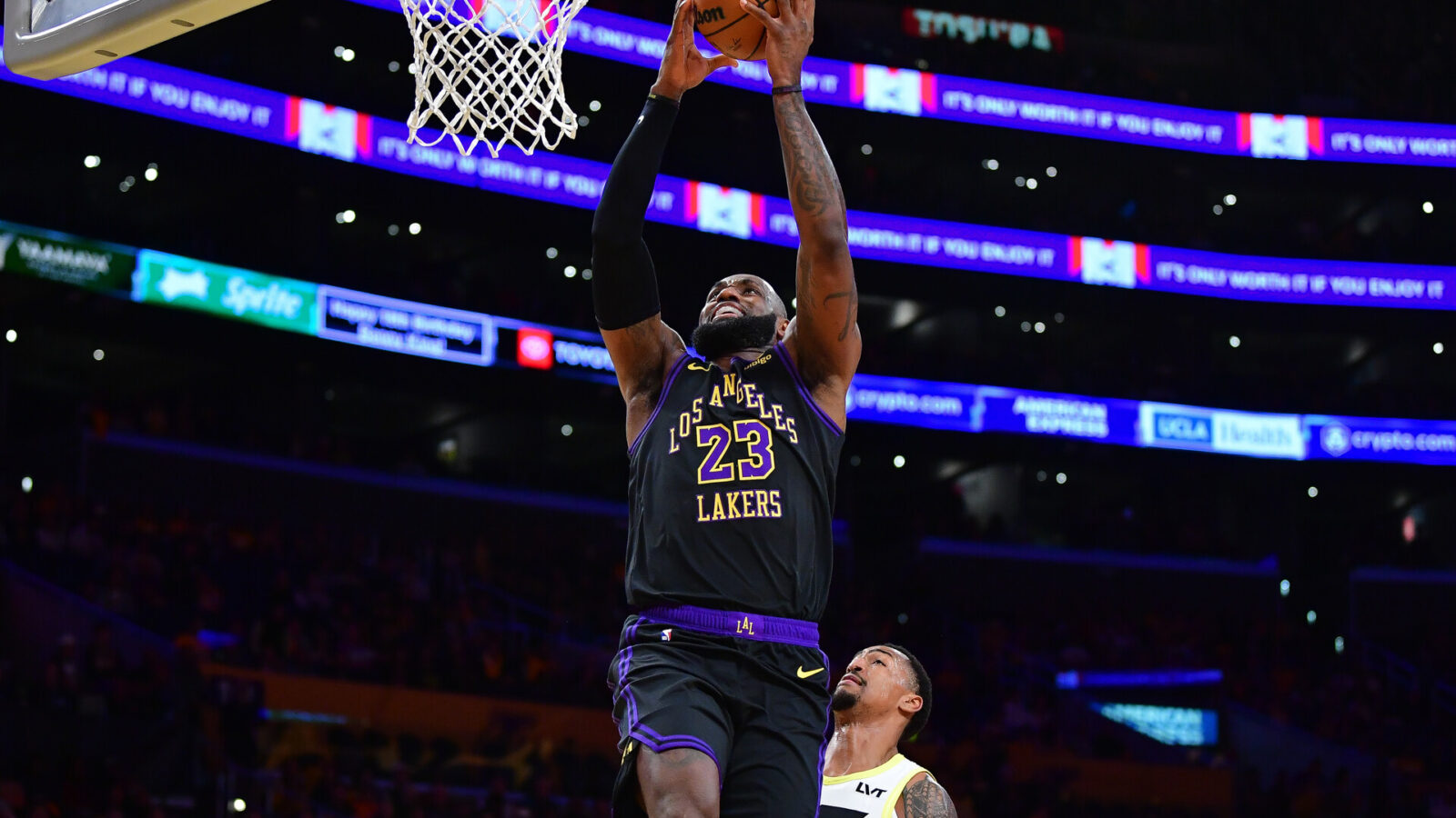 Nov 21, 2023; Los Angeles, California, USA; Los Angeles Lakers forward LeBron James (23) scores a basket ahead of Utah Jazz forward John Collins (20) during the first half at Crypto.com Arena.