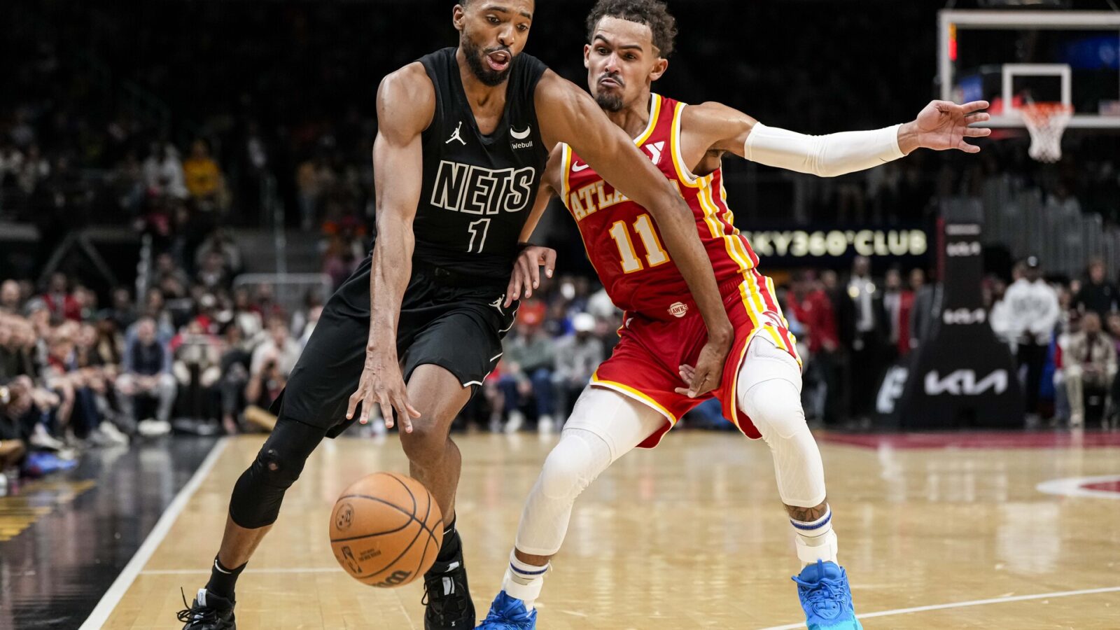 Nov 22, 2023; Atlanta, Georgia, USA; Brooklyn Nets forward Mikal Bridges (1) works against the defense of Atlanta Hawks guard Trae Young (11) during overtime at State Farm Arena.