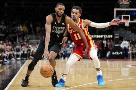Nov 22, 2023; Atlanta, Georgia, USA; Brooklyn Nets forward Mikal Bridges (1) works against the defense of Atlanta Hawks guard Trae Young (11) during overtime at State Farm Arena.