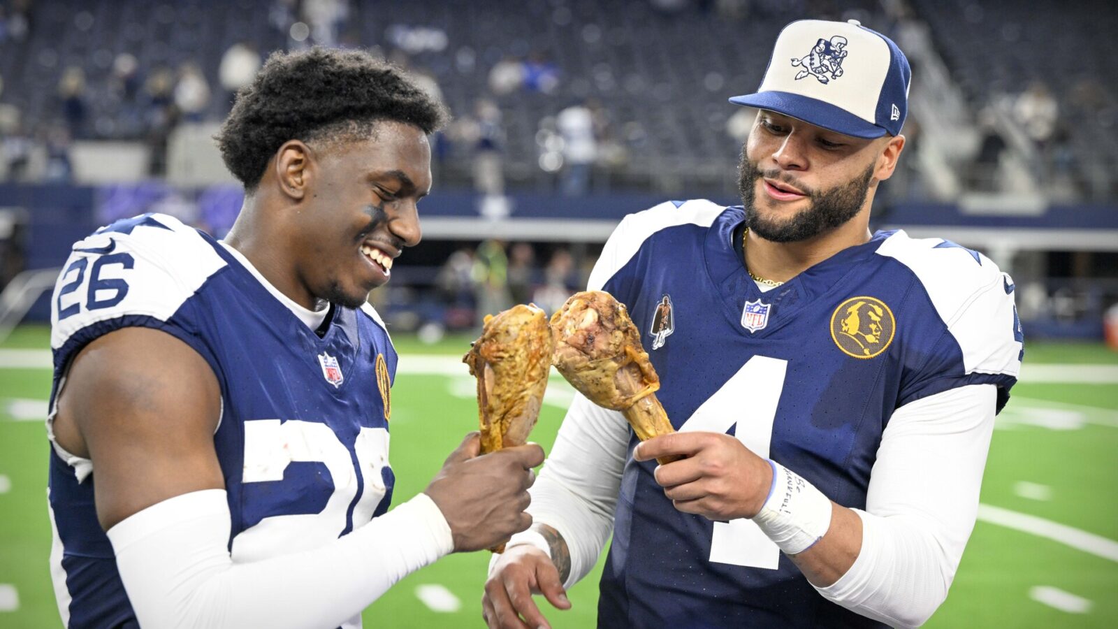 Nov 23, 2023; Arlington, Texas, USA; Dallas Cowboys cornerback DaRon Bland (26) and quarterback Dak Prescott (4) eat turkey legs after the Cowboys victory over the Washington Commanders at AT&T Stadium.