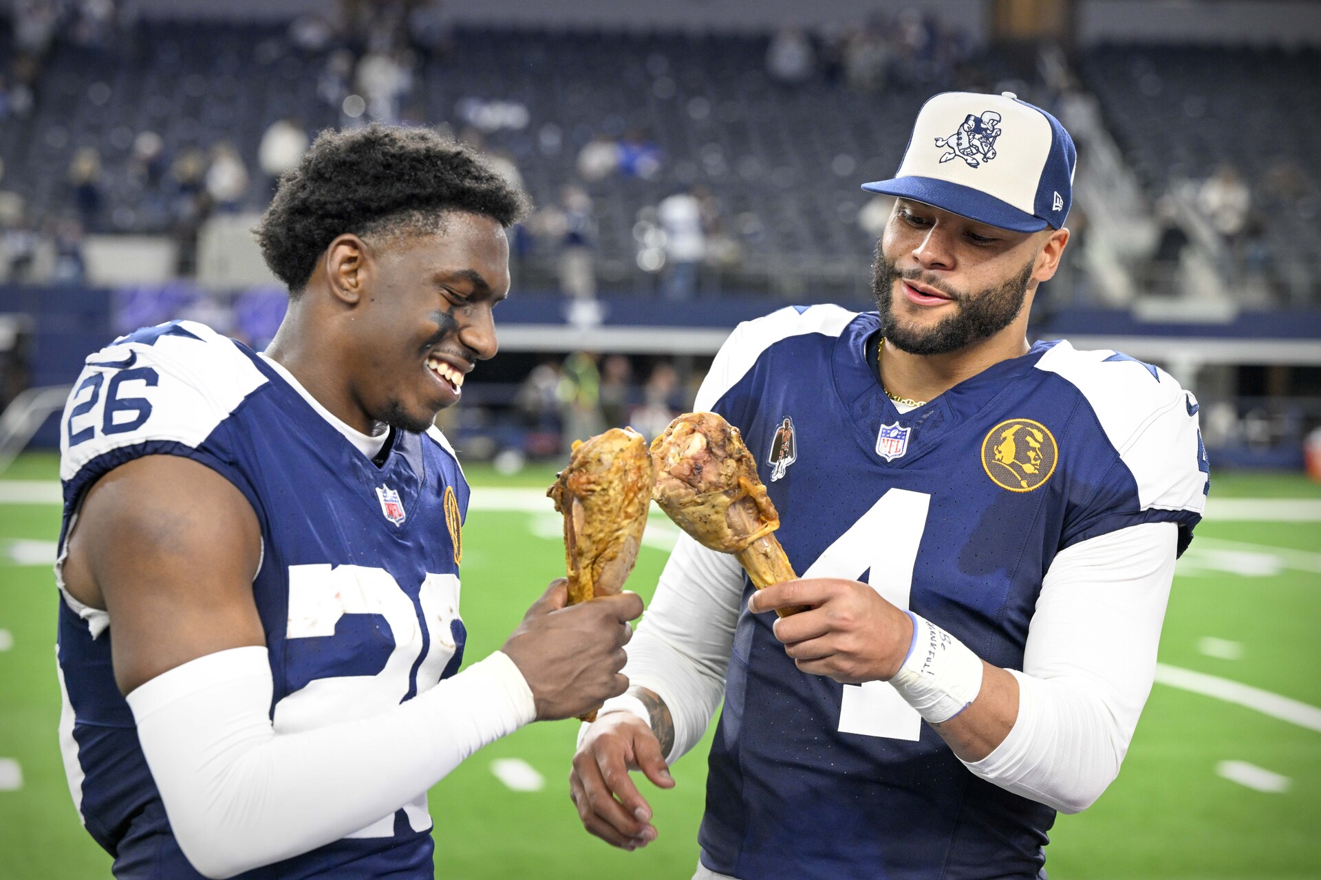 Nov 23, 2023; Arlington, Texas, USA; Dallas Cowboys cornerback DaRon Bland (26) and quarterback Dak Prescott (4) eat turkey legs after the Cowboys victory over the Washington Commanders at AT&T Stadium.