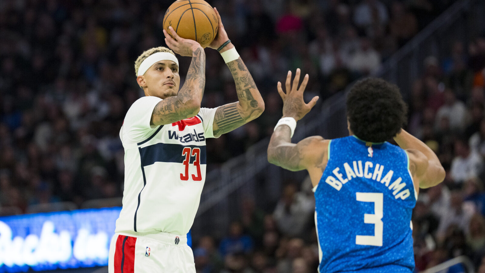 Nov 24, 2023; Milwaukee, Wisconsin, USA; Washington Wizards forward Kyle Kuzma (33) shoots over Milwaukee Bucks guard MarJon Beauchamp (3) during the first quarter at Fiserv Forum.