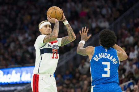 Nov 24, 2023; Milwaukee, Wisconsin, USA; Washington Wizards forward Kyle Kuzma (33) shoots over Milwaukee Bucks guard MarJon Beauchamp (3) during the first quarter at Fiserv Forum.