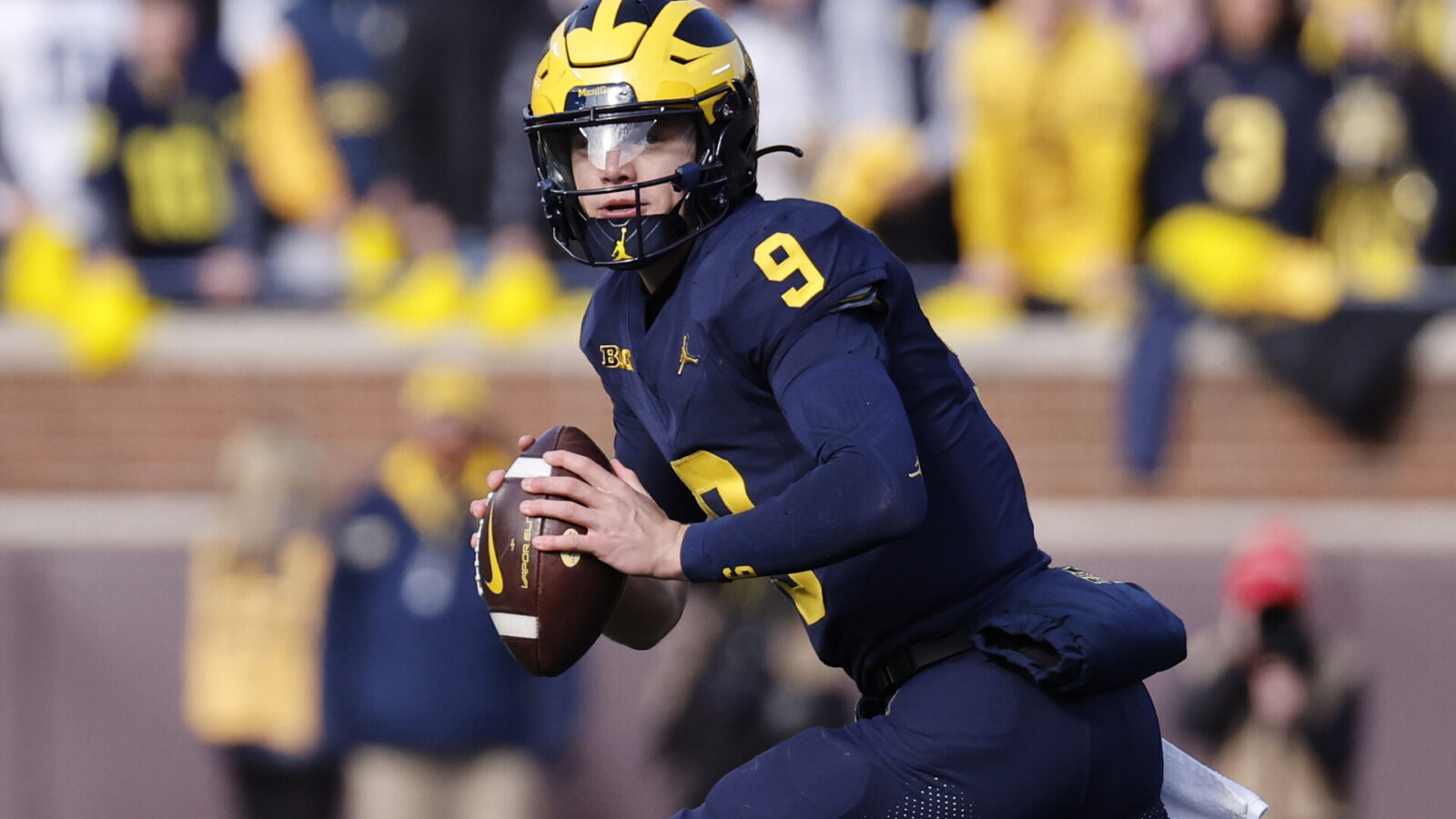 Nov 25, 2023; Ann Arbor, Michigan, USA; Michigan Wolverines quarterback J.J. McCarthy (9) rolls out to pass in the first half against the Ohio State Buckeyes at Michigan Stadium.