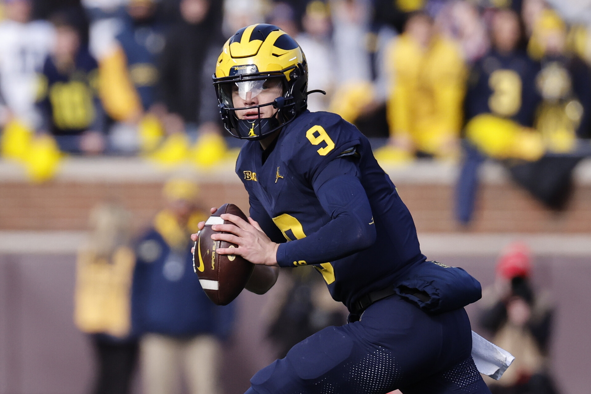 Nov 25, 2023; Ann Arbor, Michigan, USA; Michigan Wolverines quarterback J.J. McCarthy (9) rolls out to pass in the first half against the Ohio State Buckeyes at Michigan Stadium.
