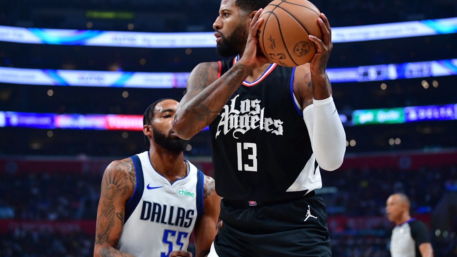Nov 25, 2023; Los Angeles, California, USA; Los Angeles Clippers forward Paul George (13) controls the ball against Dallas Mavericks forward Derrick Jones Jr. (55) during the first half at Crypto.com Arena.