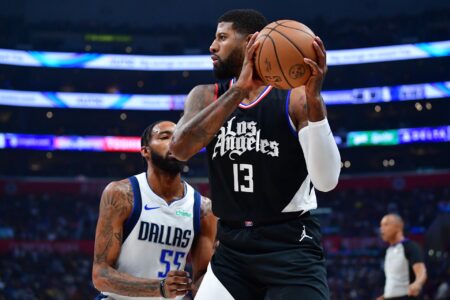 Nov 25, 2023; Los Angeles, California, USA; Los Angeles Clippers forward Paul George (13) controls the ball against Dallas Mavericks forward Derrick Jones Jr. (55) during the first half at Crypto.com Arena.