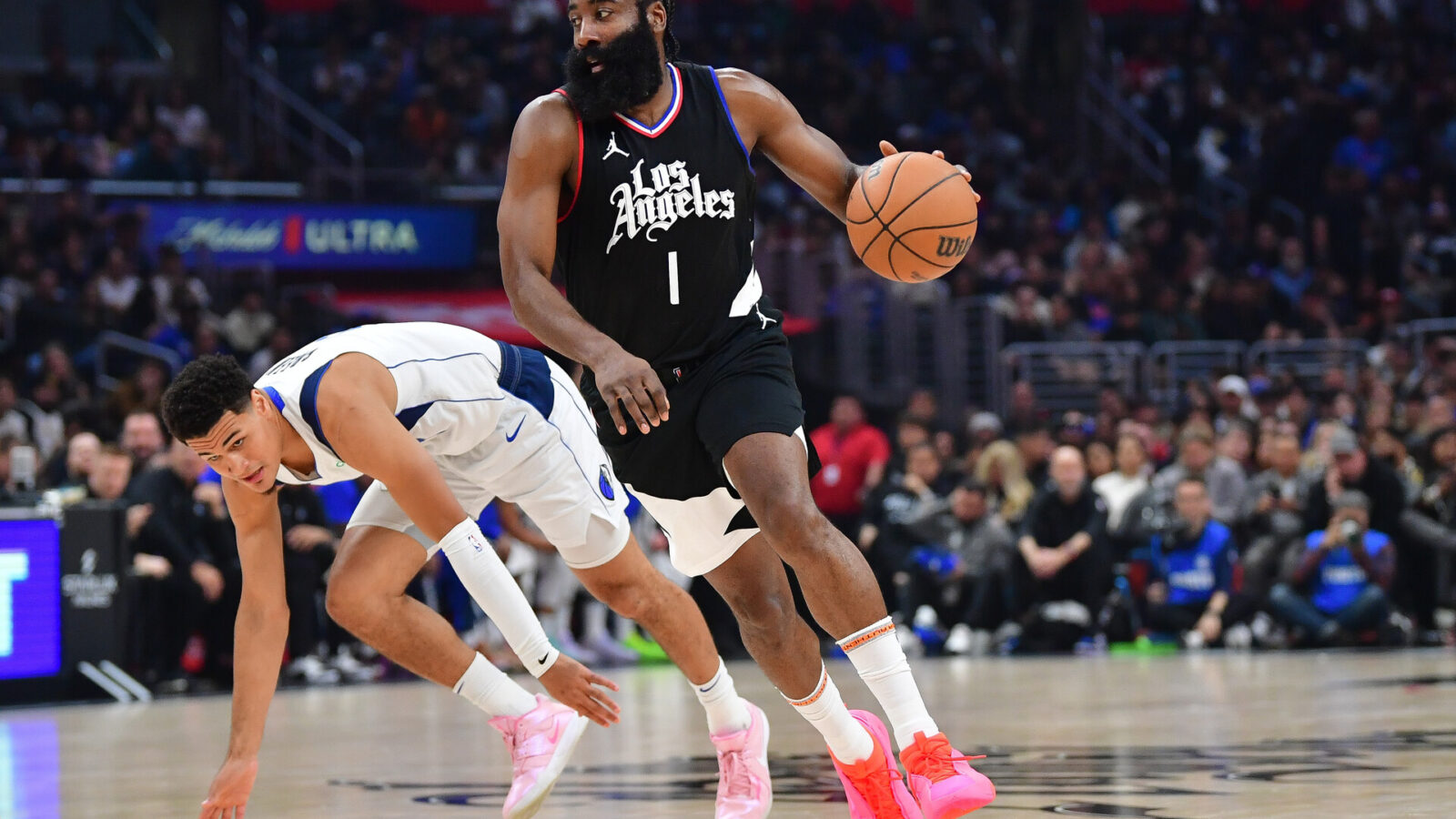 Nov 25, 2023; Los Angeles, California, USA; Los Angeles Clippers guard James Harden (1) moves the ball ahead of Dallas Mavericks guard Josh Green (8) during the first half at Crypto.com Arena.