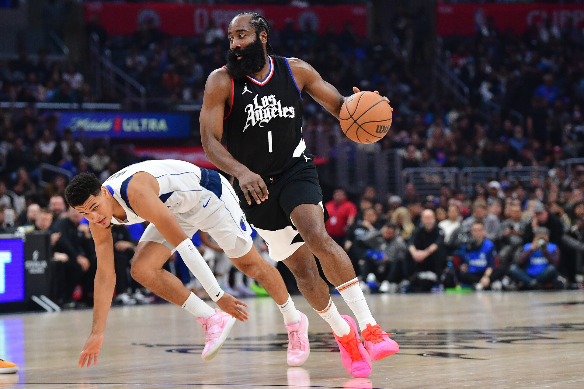 Nov 25, 2023; Los Angeles, California, USA; Los Angeles Clippers guard James Harden (1) moves the ball ahead of Dallas Mavericks guard Josh Green (8) during the first half at Crypto.com Arena.