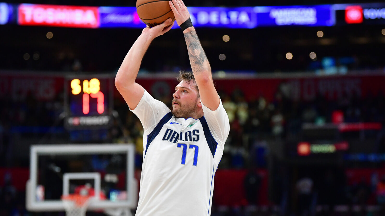 Nov 25, 2023; Los Angeles, California, USA; Dallas Mavericks guard Luka Doncic (77) shoots against the Los Angeles Clippers during the second half Crypto.com Arena.