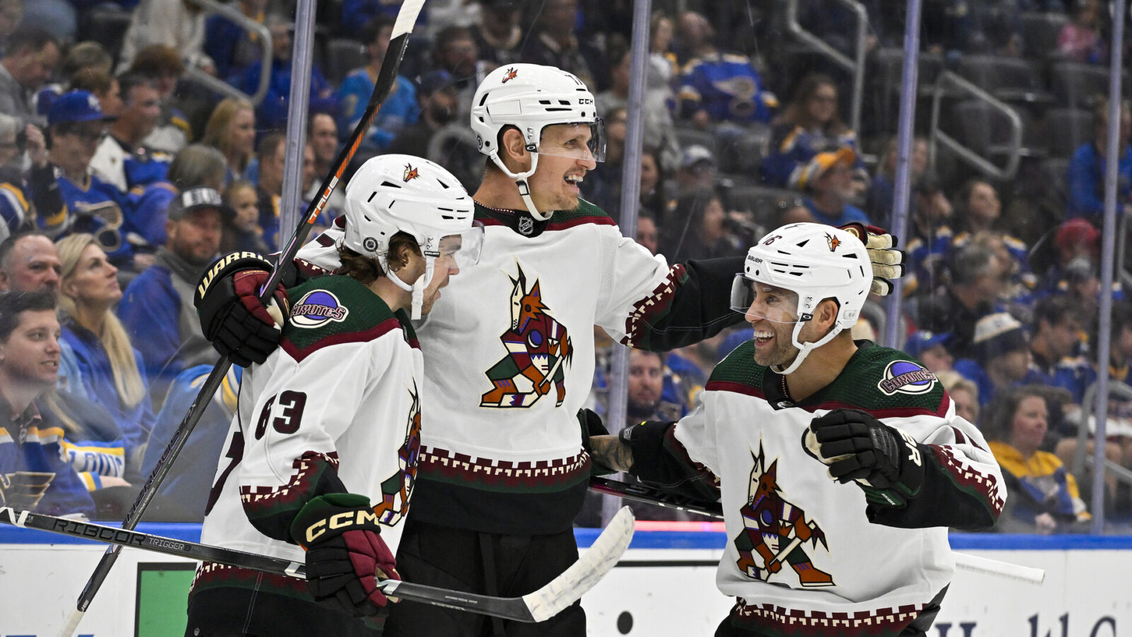 Oct 19, 2023; St. Louis, Missouri, USA; Arizona Coyotes center Nick Bjugstad (17) celebrates with left wing Matias Maccelli (63) and left wing Jason Zucker (16) after scoring against the St. Louis Blues during the first period at Enterprise Center.