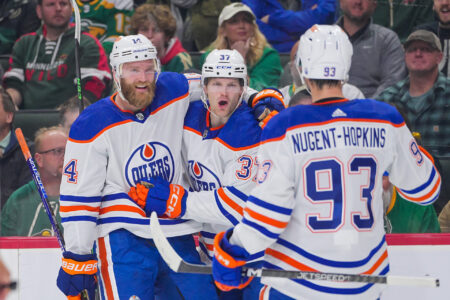 Oct 24, 2023; Saint Paul, Minnesota, USA; Edmonton Oilers left wing Warren Foegele (37) celebrates his goal with defenseman Mattias Ekholm (14) against the Minnesota Wild in the first period at Xcel Energy Center.