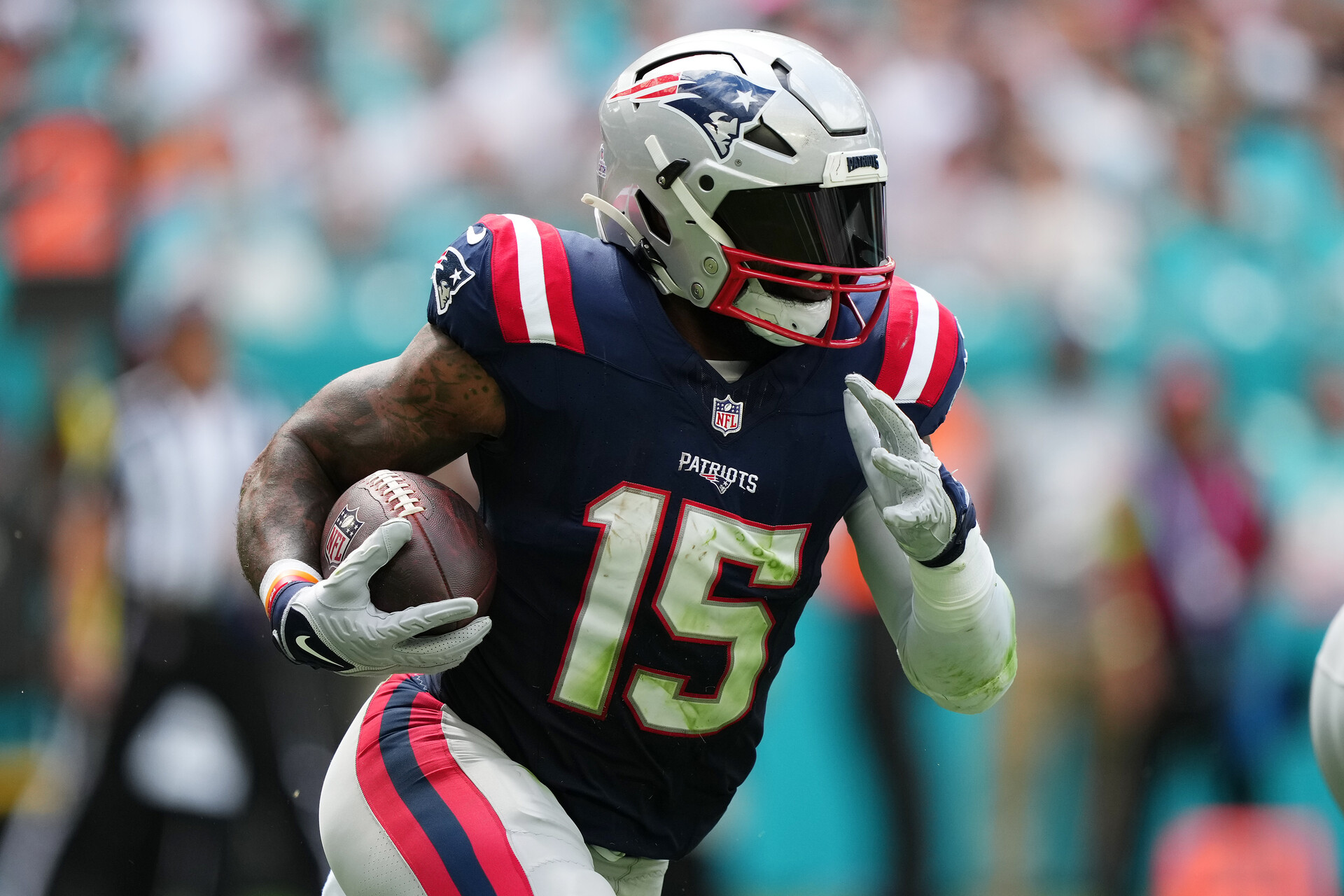New England Patriots running back Ezekiel Elliott (15) runs the ball against the Miami Dolphins during the first half at Hard Rock Stadium.