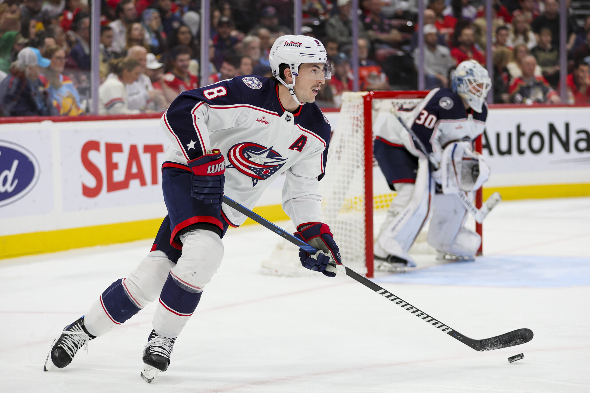 Nov 6, 2023; Sunrise, Florida, USA; Columbus Blue Jackets defenseman Zach Werenski (8) moves the puck against the Florida Panthers during the second period at Amerant Bank Arena.
