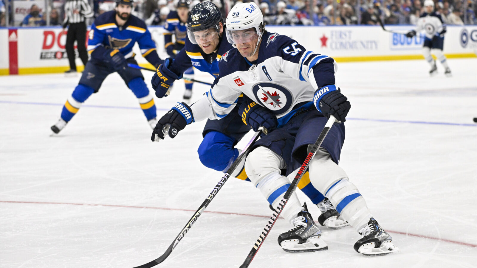 Nov 7, 2023; St. Louis, Missouri, USA; Winnipeg Jets center Mark Scheifele (55) controls the puck as St. Louis Blues defenseman Colton Parayko (55) defends during the third period at Enterprise Center.