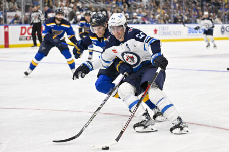 Nov 7, 2023; St. Louis, Missouri, USA; Winnipeg Jets center Mark Scheifele (55) controls the puck as St. Louis Blues defenseman Colton Parayko (55) defends during the third period at Enterprise Center.