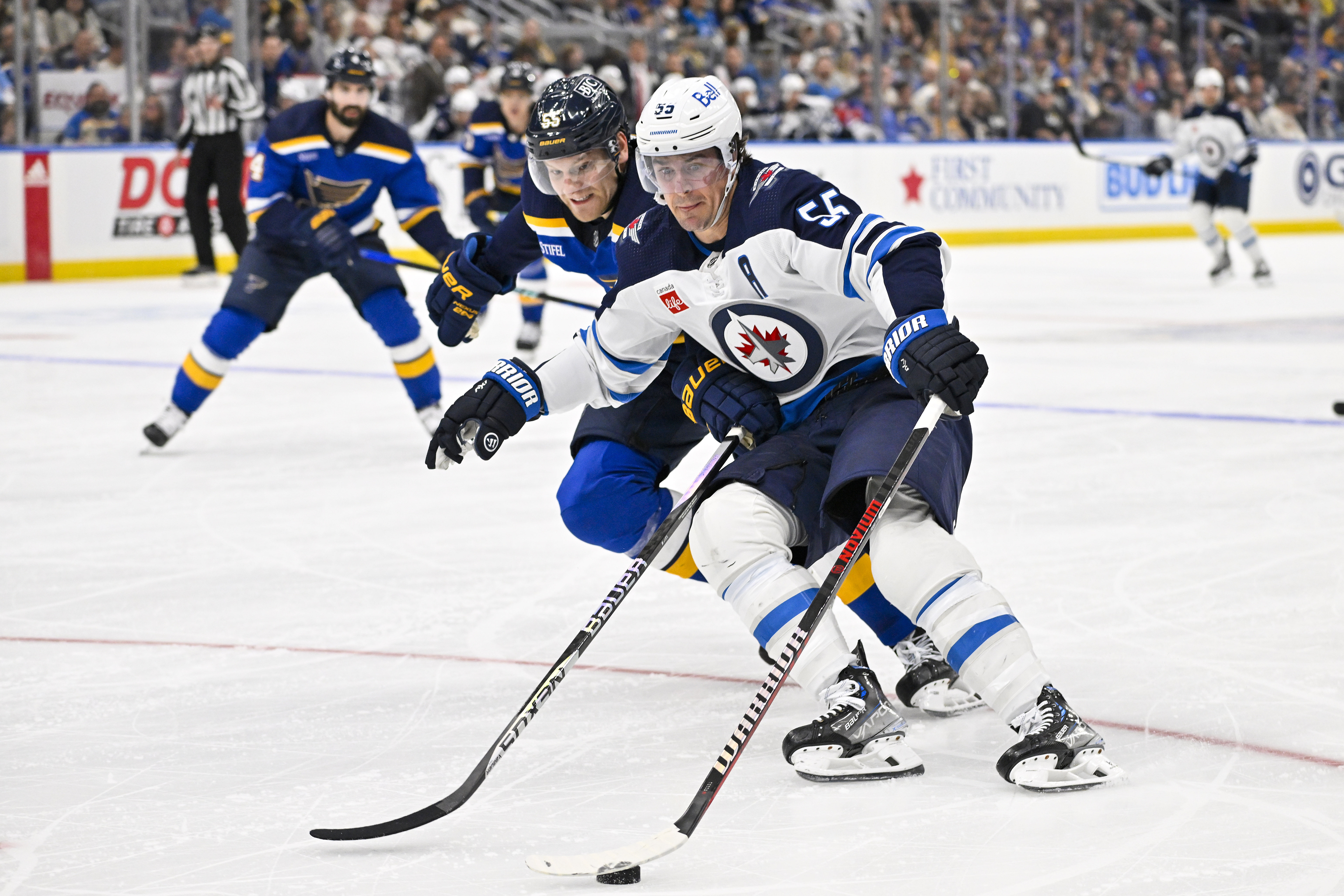 Nov 7, 2023; St. Louis, Missouri, USA; Winnipeg Jets center Mark Scheifele (55) controls the puck as St. Louis Blues defenseman Colton Parayko (55) defends during the third period at Enterprise Center.