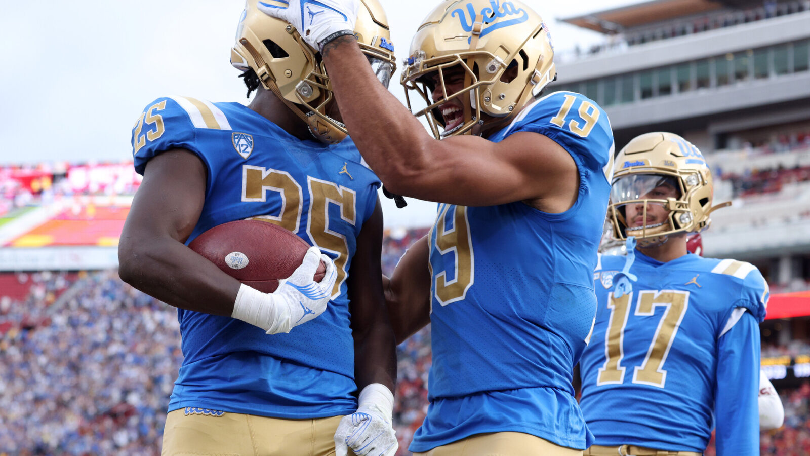UCLA Bruins running back TJ Harden (25) celebrates with wide receiver Kyle Ford (19) after a touchdown during the third quarter against the USC Trojans at United Airlines Field at Los Angeles Memorial Coliseum.