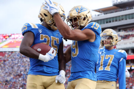 UCLA Bruins running back TJ Harden (25) celebrates with wide receiver Kyle Ford (19) after a touchdown during the third quarter against the USC Trojans at United Airlines Field at Los Angeles Memorial Coliseum.