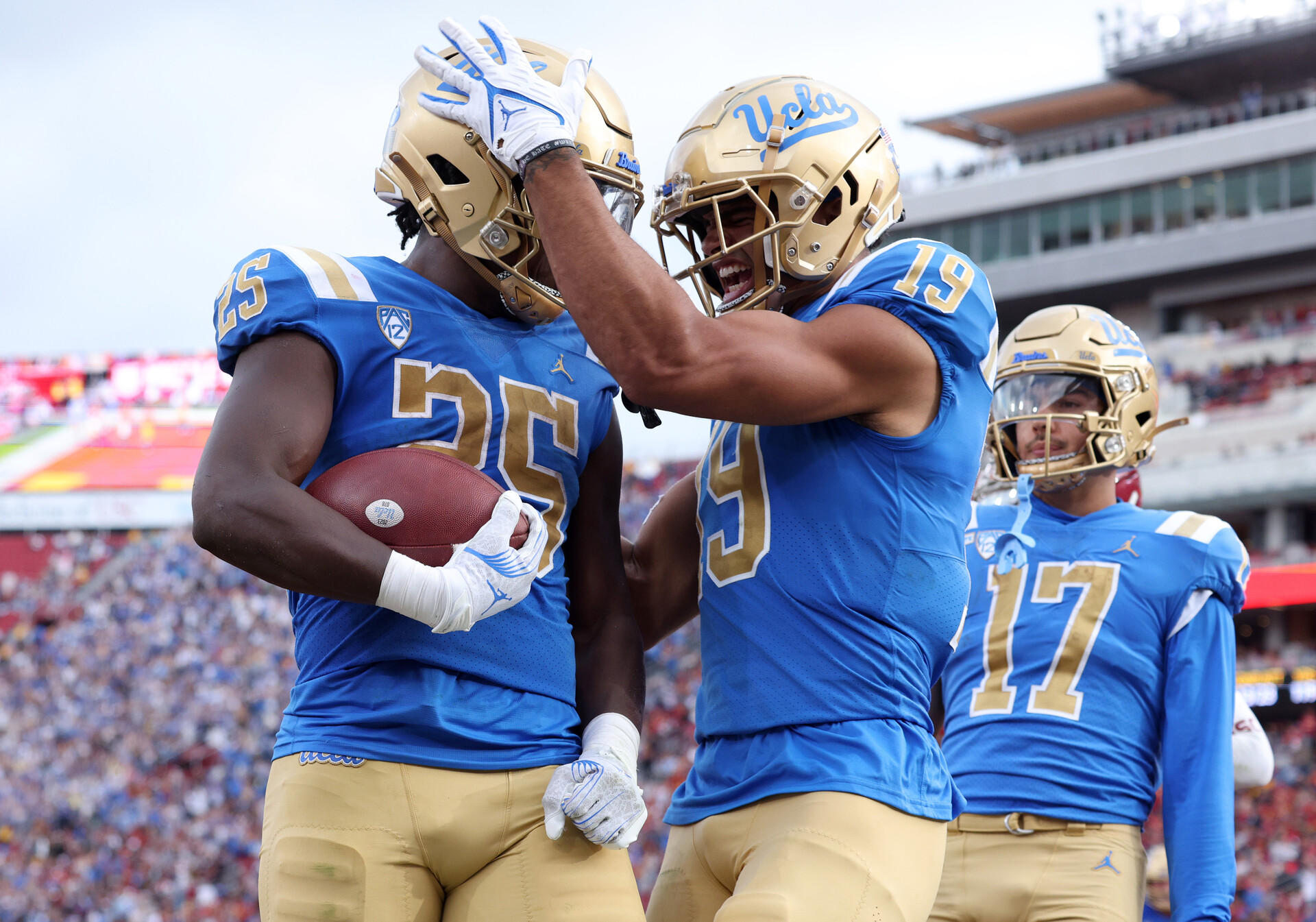 UCLA Bruins running back TJ Harden (25) celebrates with wide receiver Kyle Ford (19) after a touchdown during the third quarter against the USC Trojans at United Airlines Field at Los Angeles Memorial Coliseum.