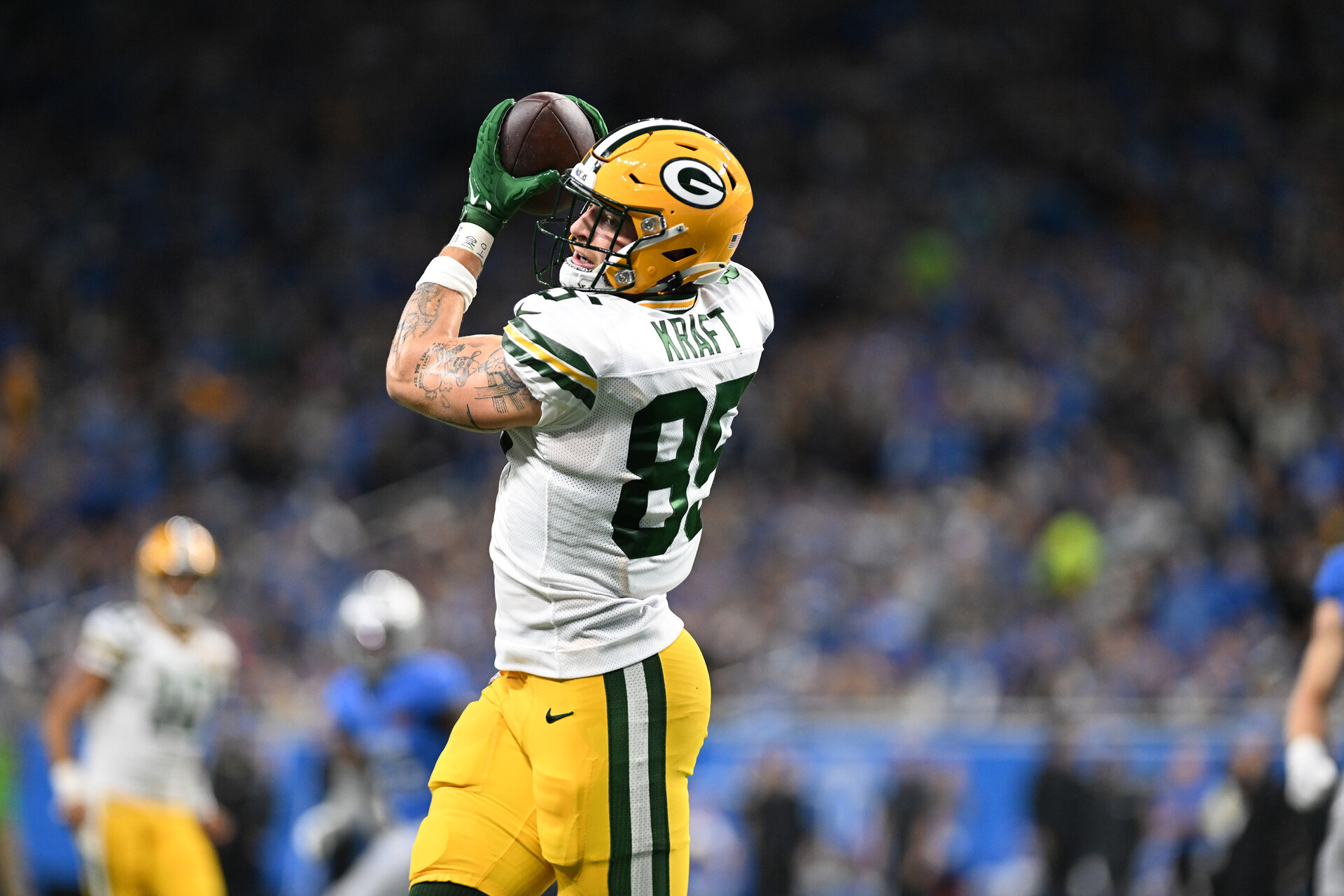Nov 23, 2023; Detroit, Michigan, USA; Green Bay Packers tight end Tucker Kraft (85) catches a touchdown pass from quarterback Jordan Love (10) (not pictured) against the Detroit Lions in the first quarter at Ford Field.