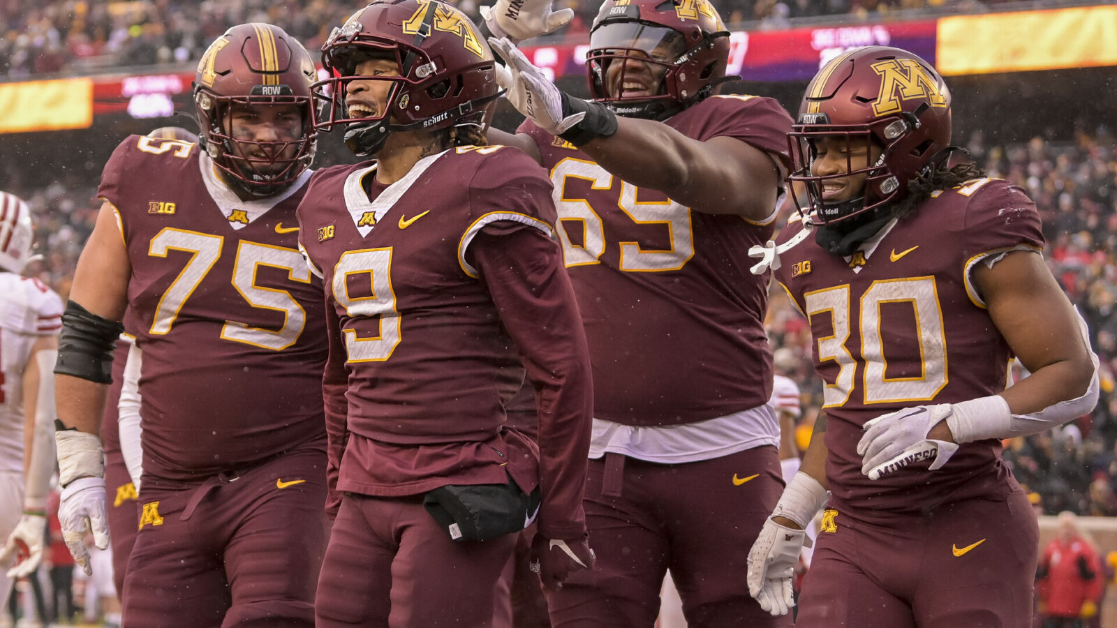 Minnesota Golden Gophers wide receiver Daniel Jackson (9) celebrates his 7-yard touchdown reception against the Wisconsin Badgers with offensive lineman Tyler Cooper (75), offensive lineman Aireontae Ersery (69), and running back Jordan Nubin (30) during the second quarter at Huntington Bank Stadium.