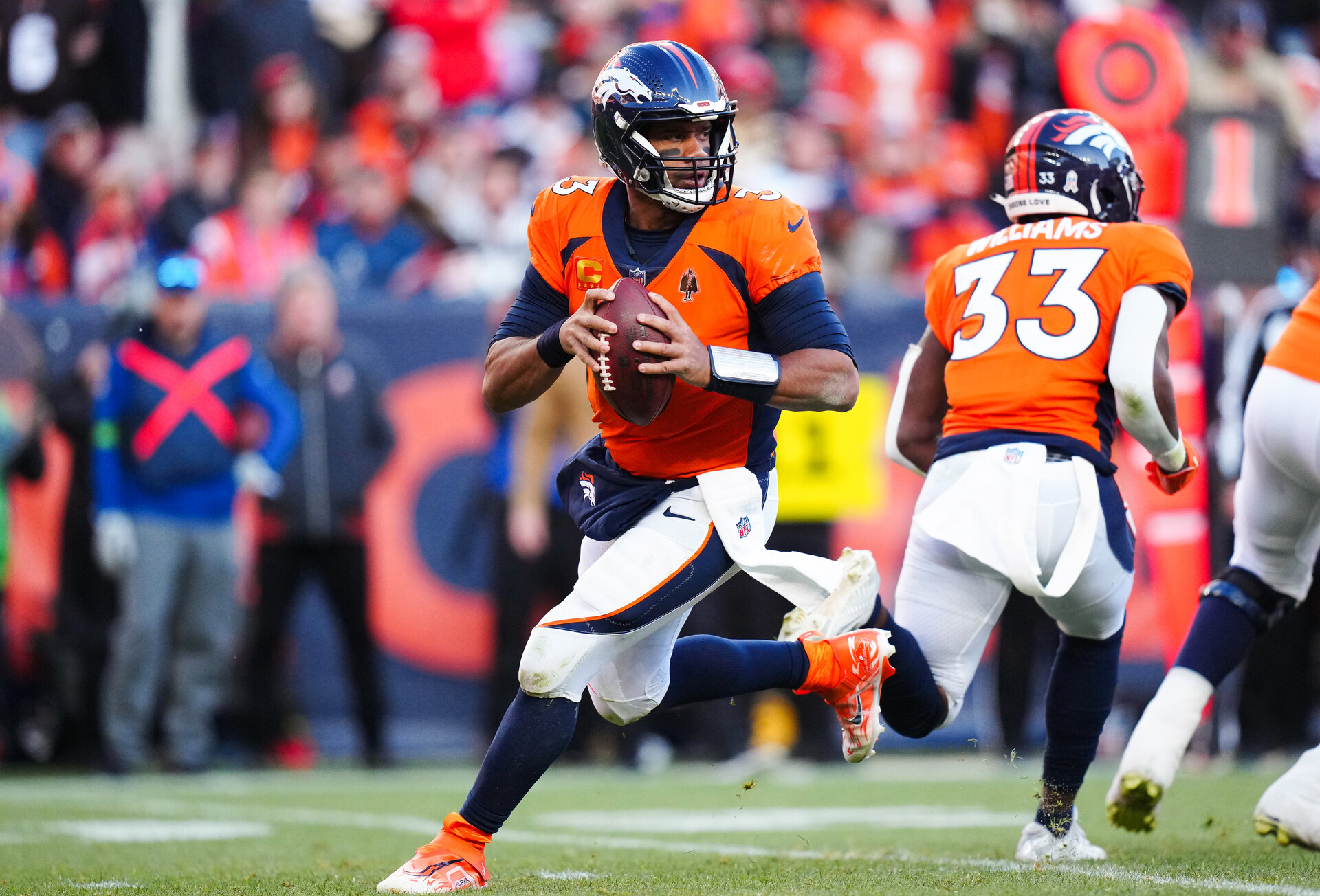 Nov 26, 2023; Denver, Colorado, USA; Denver Broncos quarterback Russell Wilson (3) scrambles in the first half against the Cleveland Browns at Empower Field at Mile High.