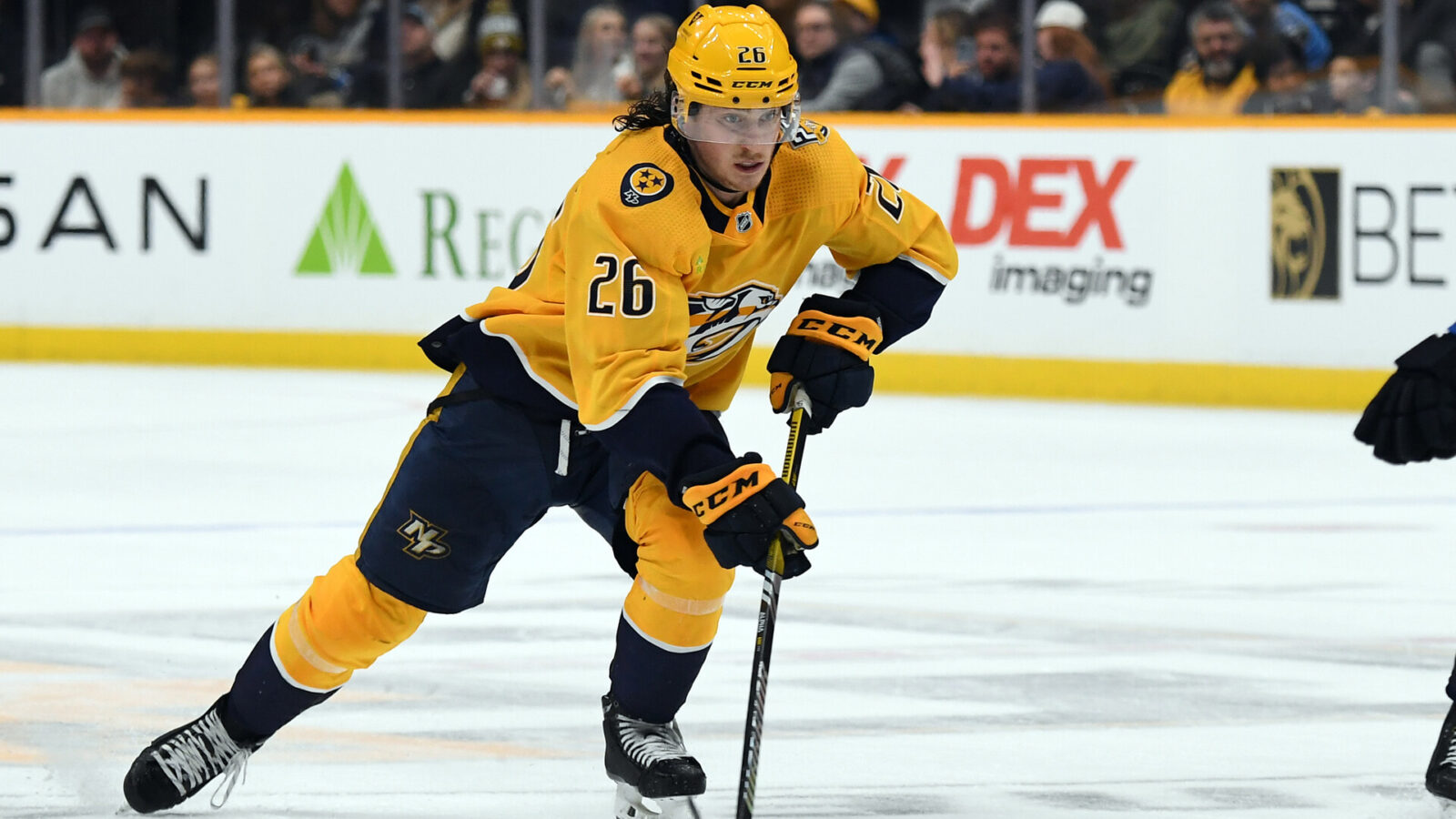 Nov 26, 2023; Nashville, Tennessee, USA; Nashville Predators center Philip Tomasino (26) handles the puck during the third period against the Winnipeg Jets at Bridgestone Arena.