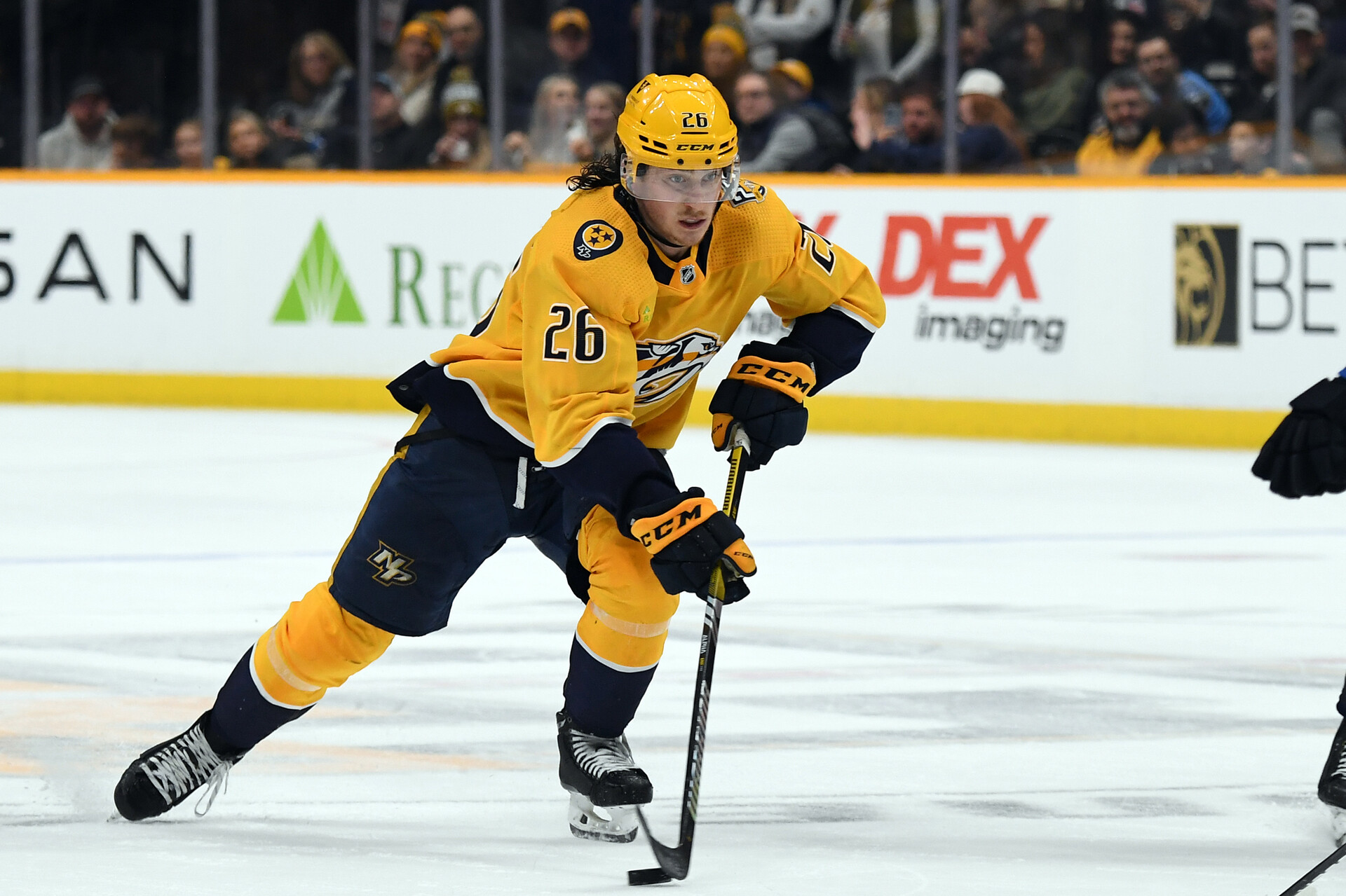 Nov 26, 2023; Nashville, Tennessee, USA; Nashville Predators center Philip Tomasino (26) handles the puck during the third period against the Winnipeg Jets at Bridgestone Arena.