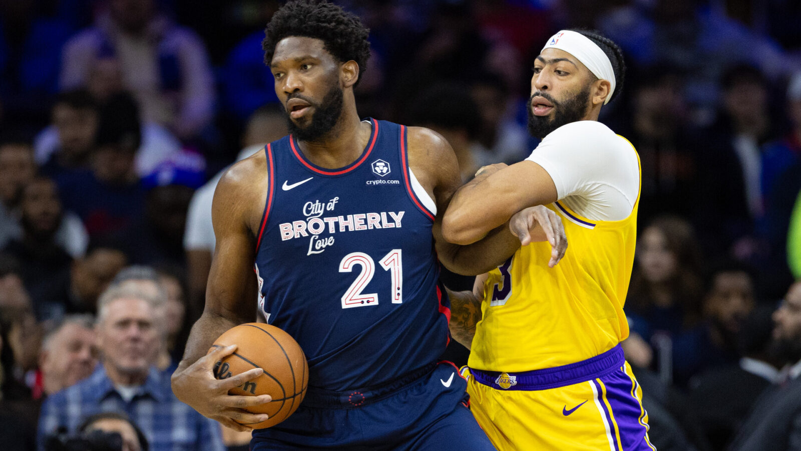 Nov 27, 2023; Philadelphia, Pennsylvania, USA; Philadelphia 76ers center Joel Embiid (21) battles for position against Los Angeles Lakers forward Anthony Davis (3) during the first quarter at Wells Fargo Center.