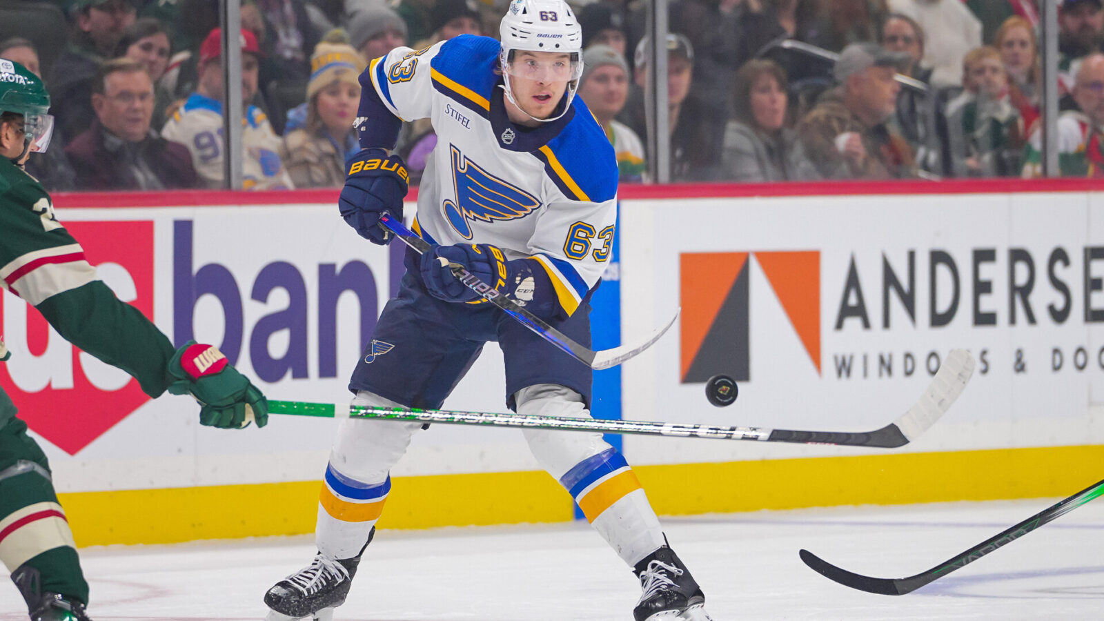 Nov 28, 2023; Saint Paul, Minnesota, USA; St. Louis Blues left wing Jake Neighbours (63) dumps the puck against the Minnesota Wild in the first period at Xcel Energy Center.