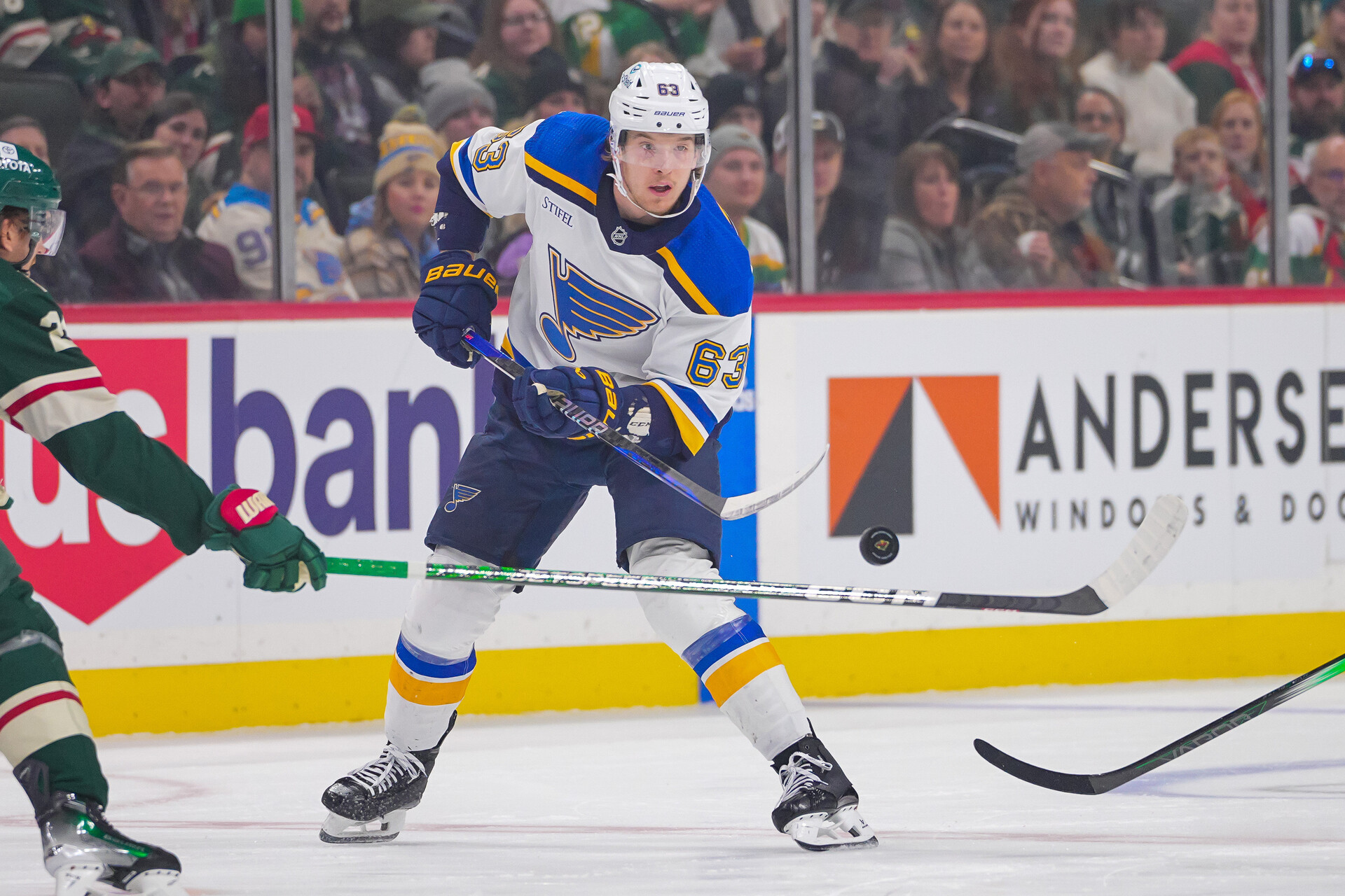 Nov 28, 2023; Saint Paul, Minnesota, USA; St. Louis Blues left wing Jake Neighbours (63) dumps the puck against the Minnesota Wild in the first period at Xcel Energy Center.